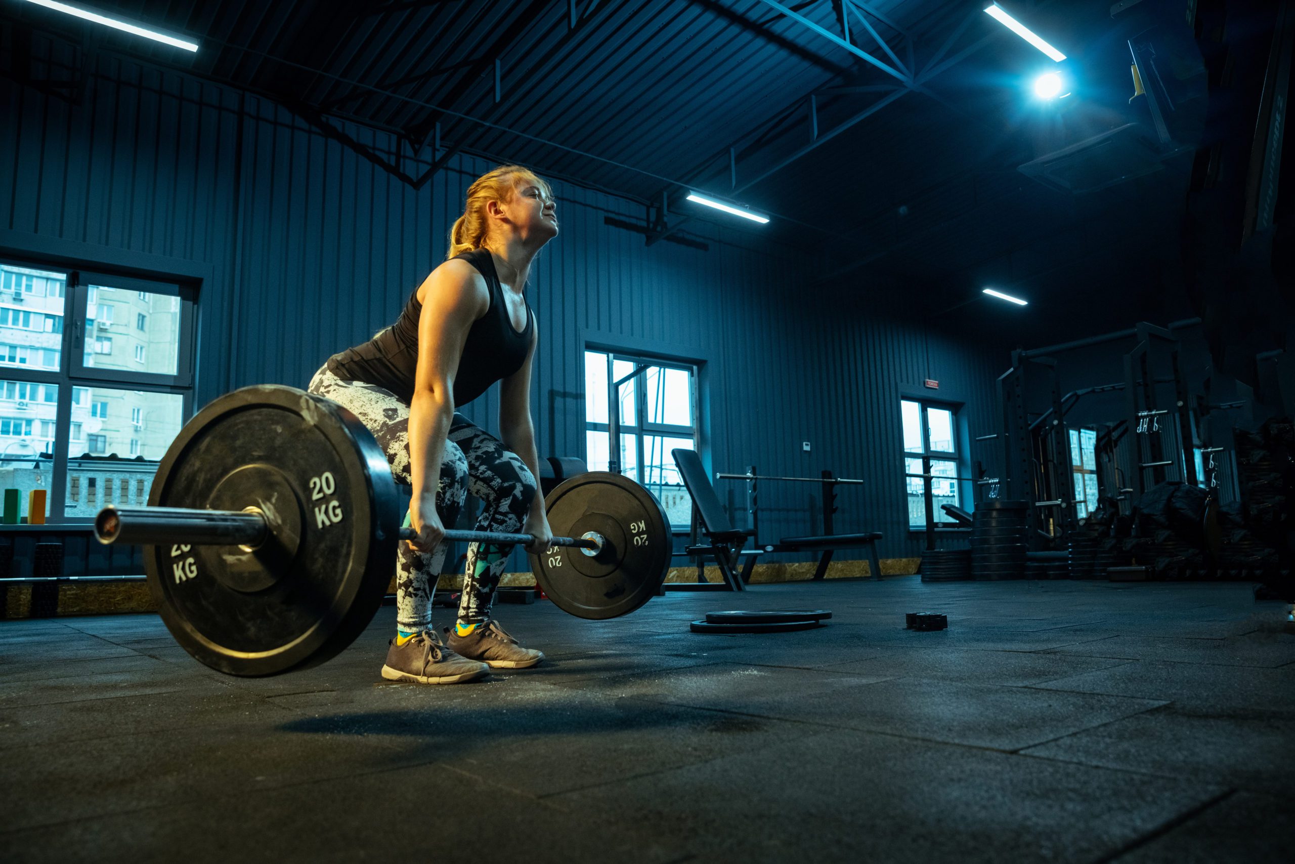 Caucasian teenage girl practicing in weightlifting in gym Clean Up Your Clean & Jerk: Mastering the Pull Header Image