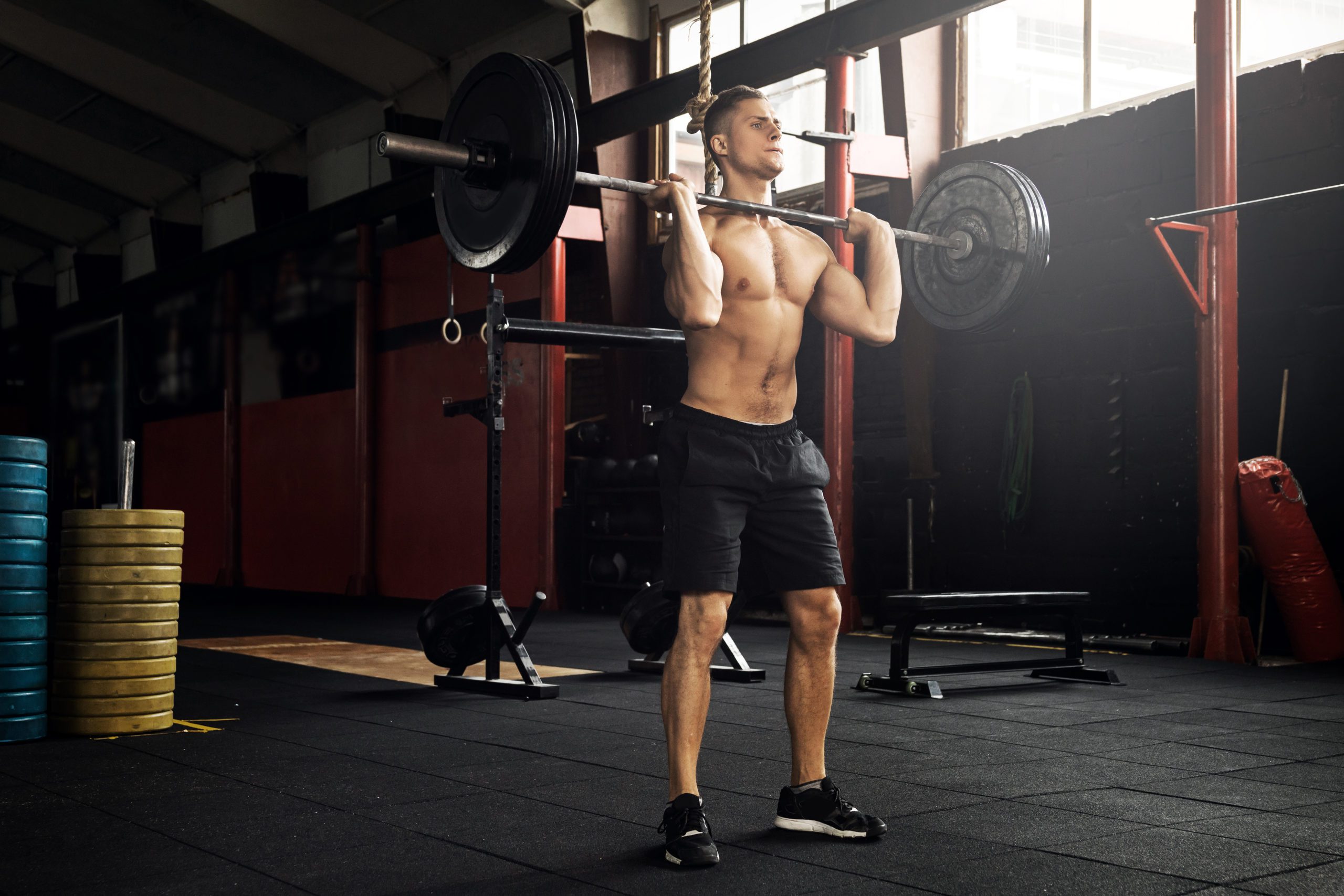 Muscular man during his weightlifting workout in the gym Master the push press