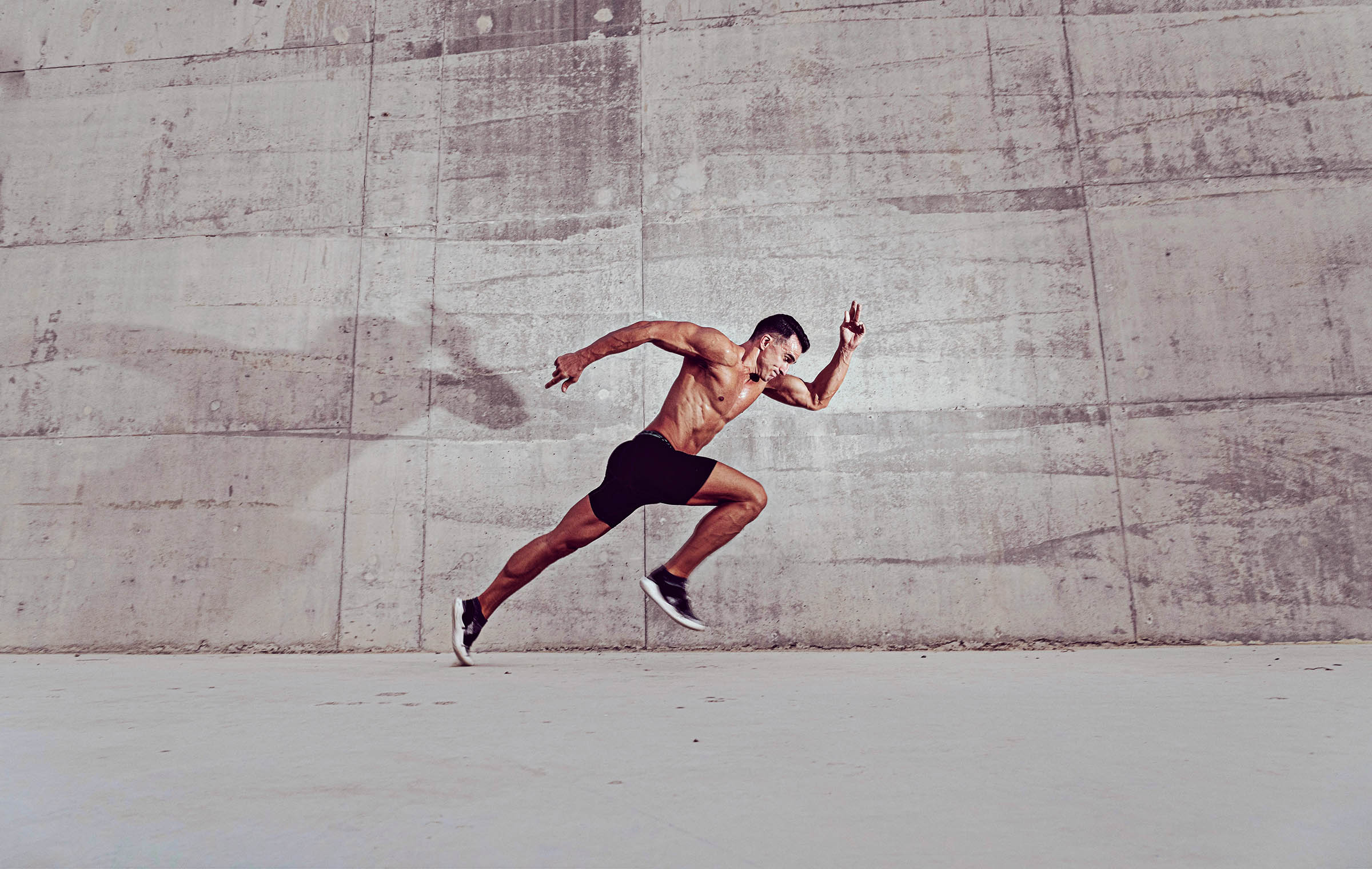 Get Faster with Overspeed Training Muscular shirtless caucasian male athlete does an explosive sprinting start
