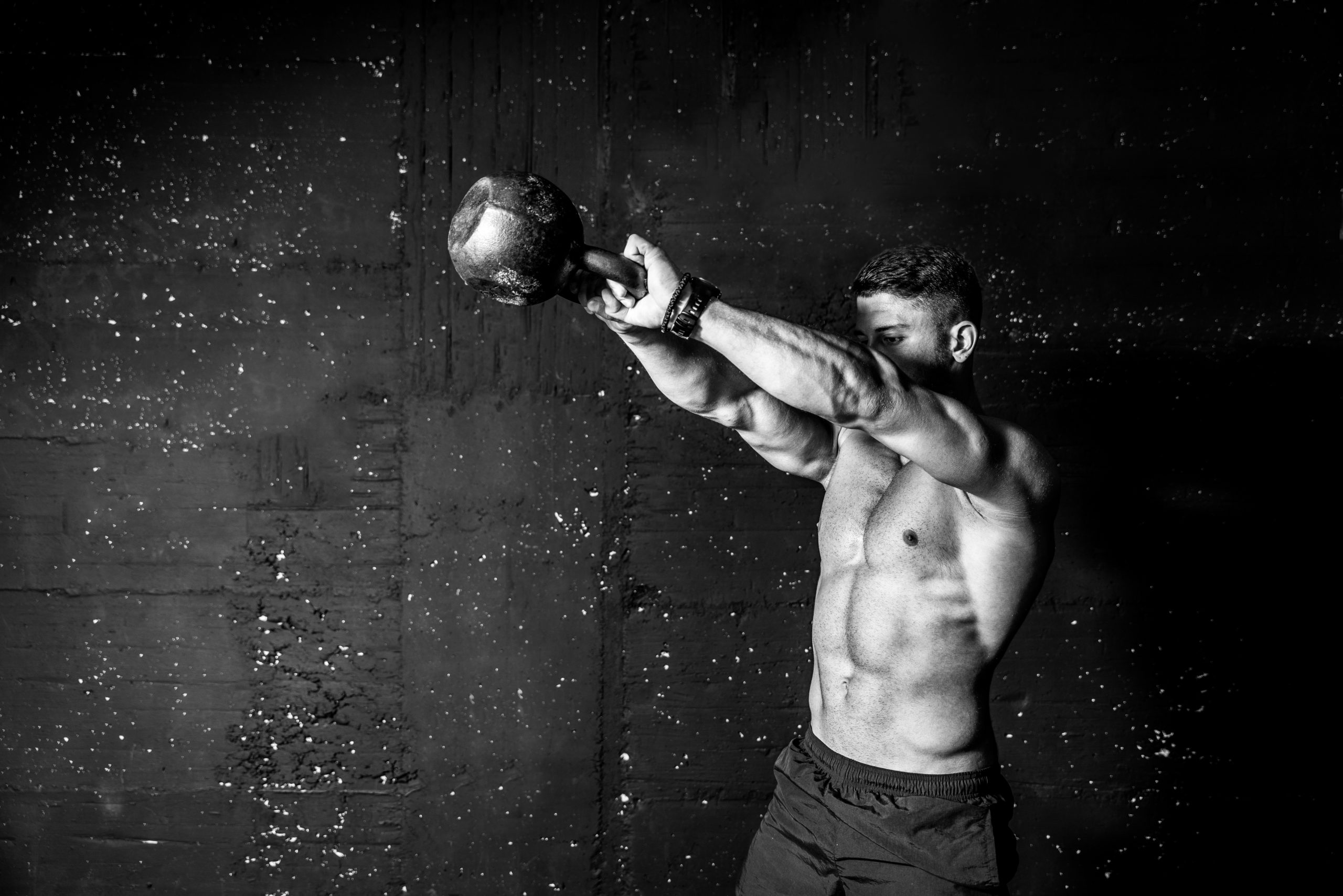 The kettlebell swing is for everyone Strong, muscular man performing the kettlebell swing