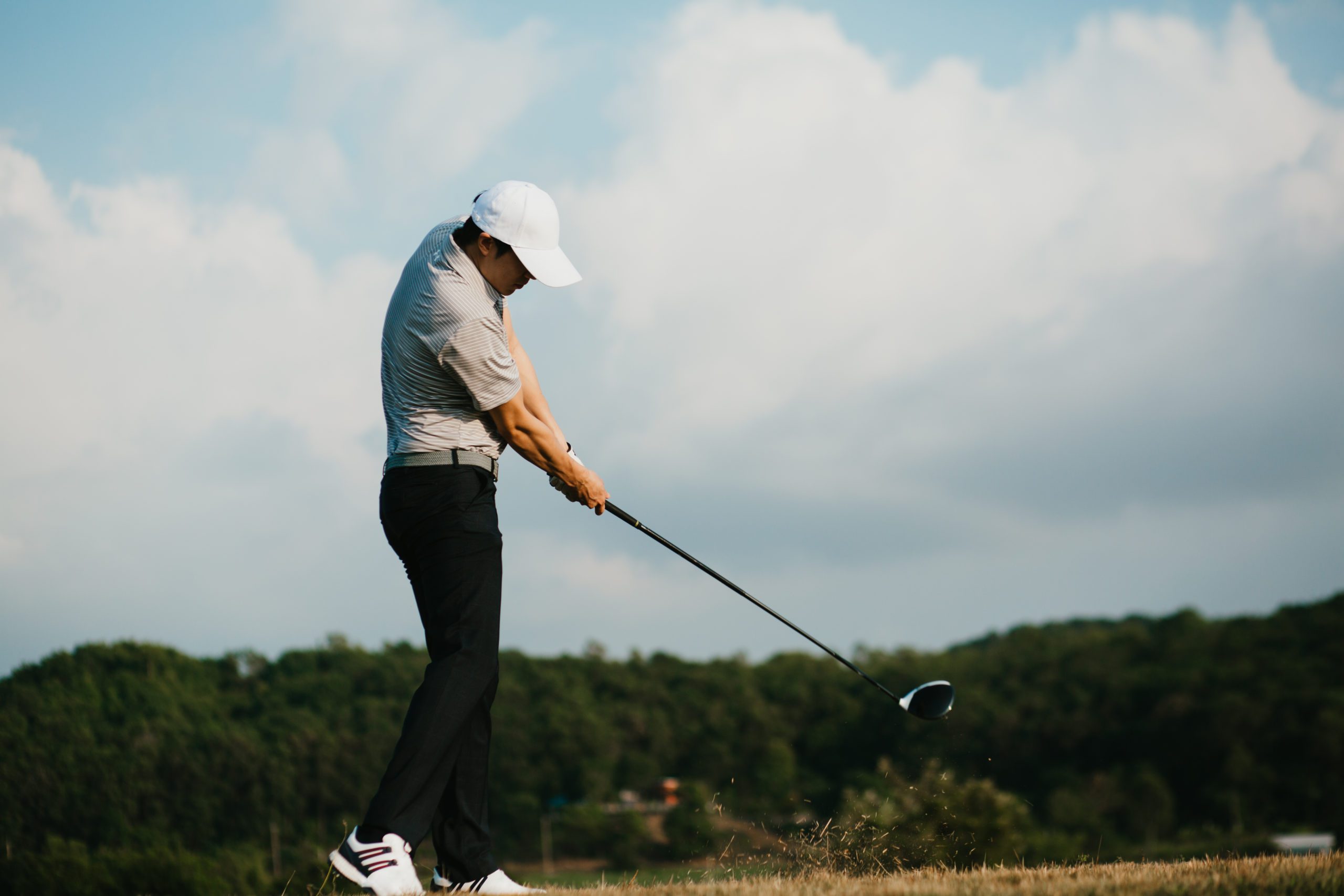 Build a Powerful Swing Golfer swinging golf club in a strong stance