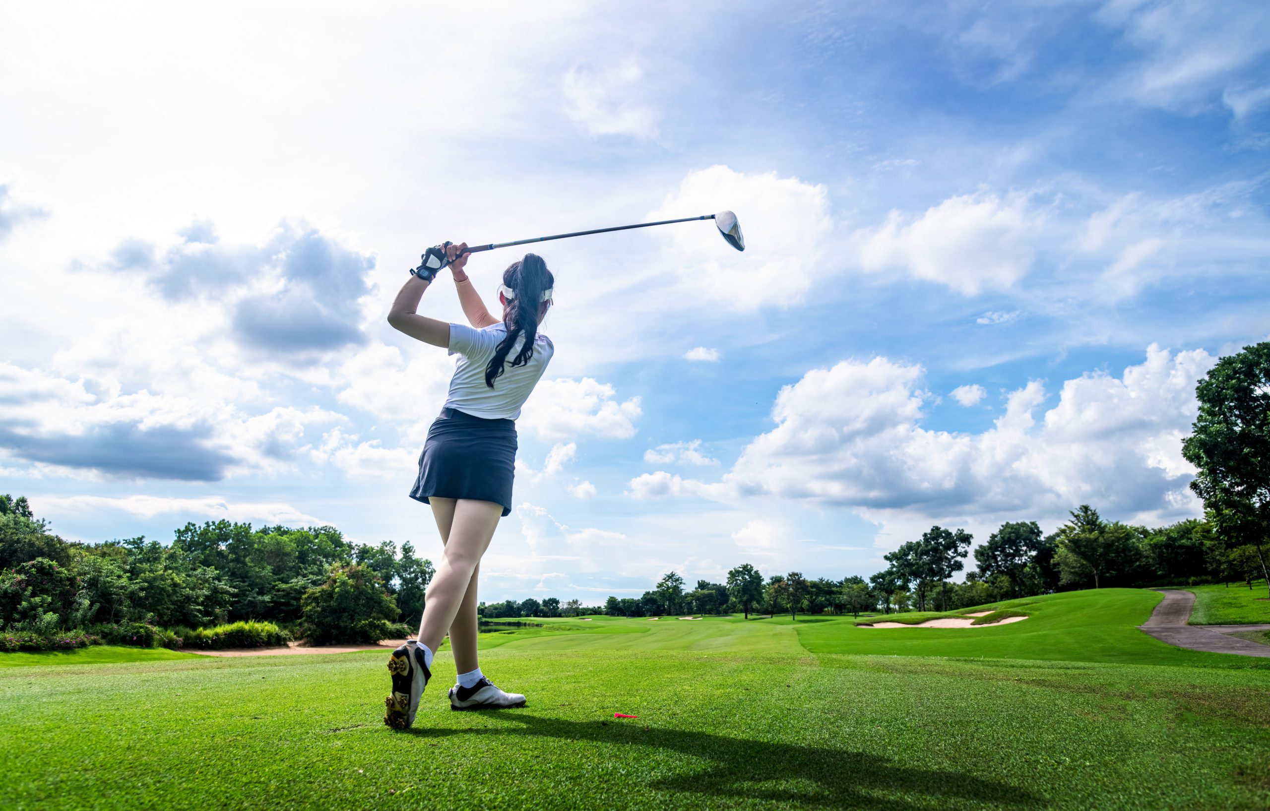 Improve Your Golf Swing Professional woman golfer teeing in golf tournament