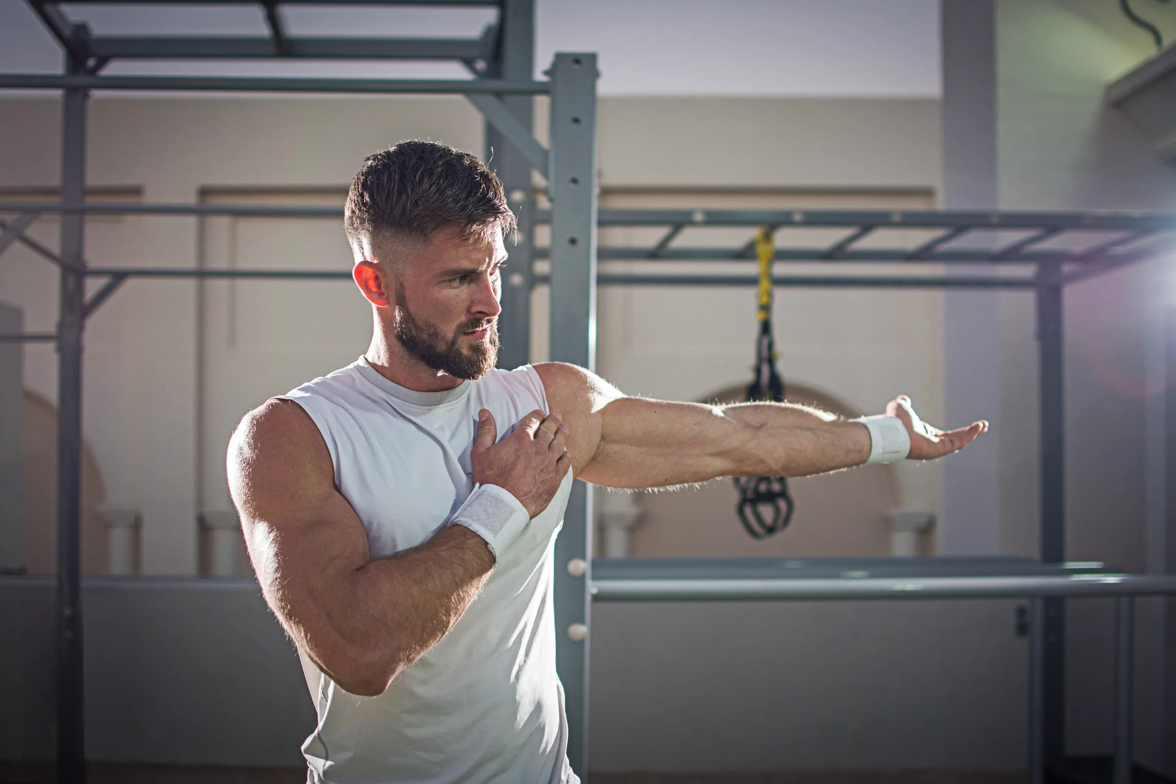 Portrait of a handsome man stretching hands at gym. kettlebell strength and conditioning