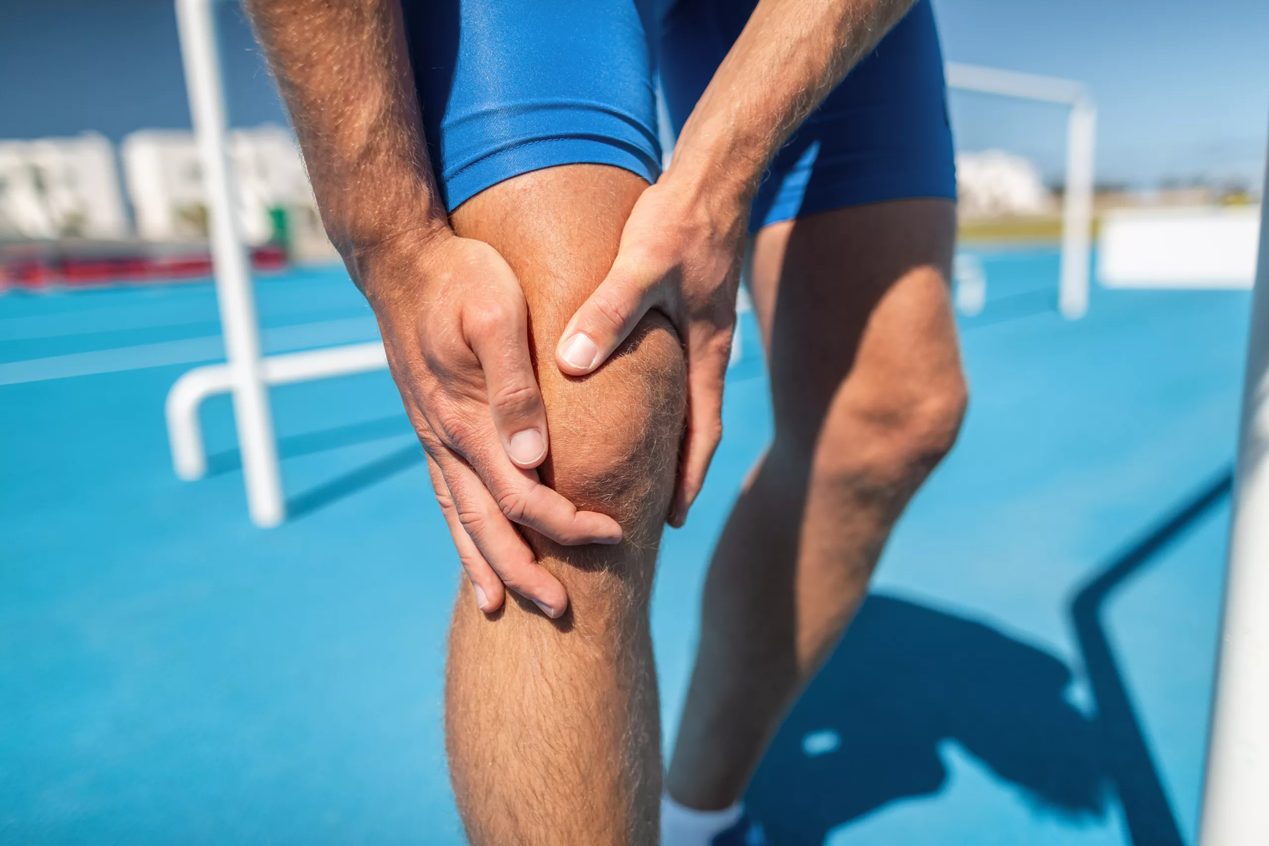 Keys to Recovery from a Sports Injury Knee pain professional athlete sport injury - sports running knee acciden on man runner. Sprained knee joint, arthritis. Closeup of legs, muscle and knee outdoors.