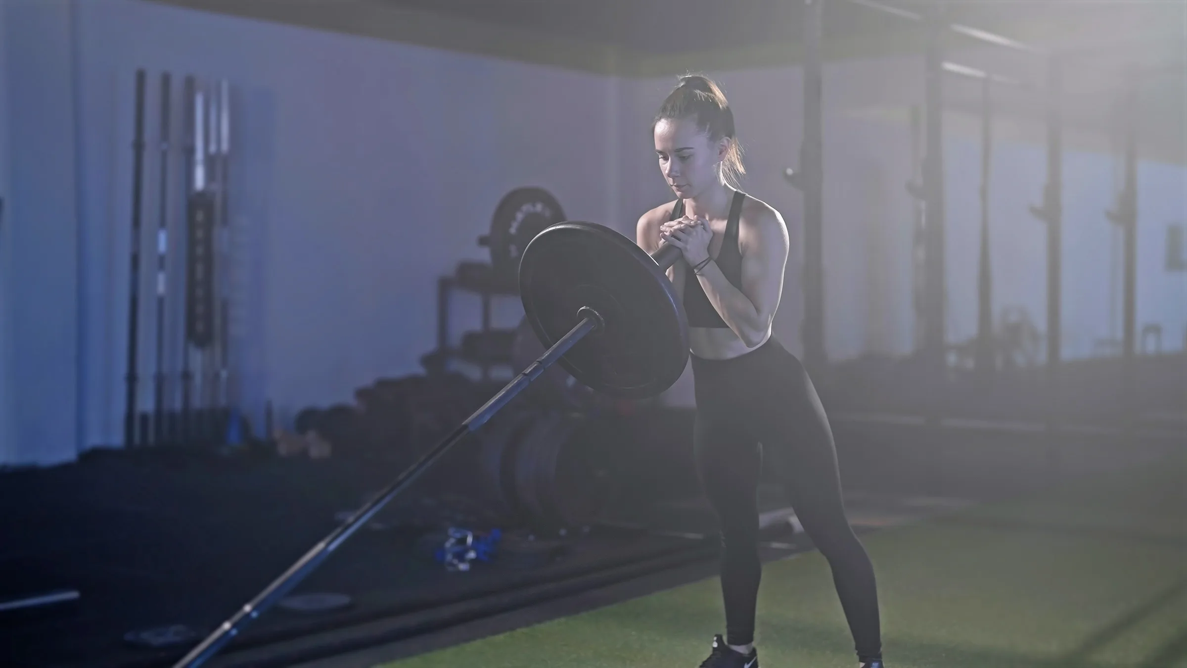 Fitness woman exercise landmine squat with barbell weightlifting landmine leg exercises for strength and conditioning athletes